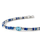 Close-up of the cushion-cut Swiss blue topaz center stone and blue enamel beads