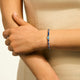 Model wearing the John Hardy Heishi Swiss blue topaz bracelet