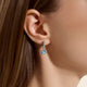 Model wearing the John Hardy Heishi Swiss blue topaz drop earrings