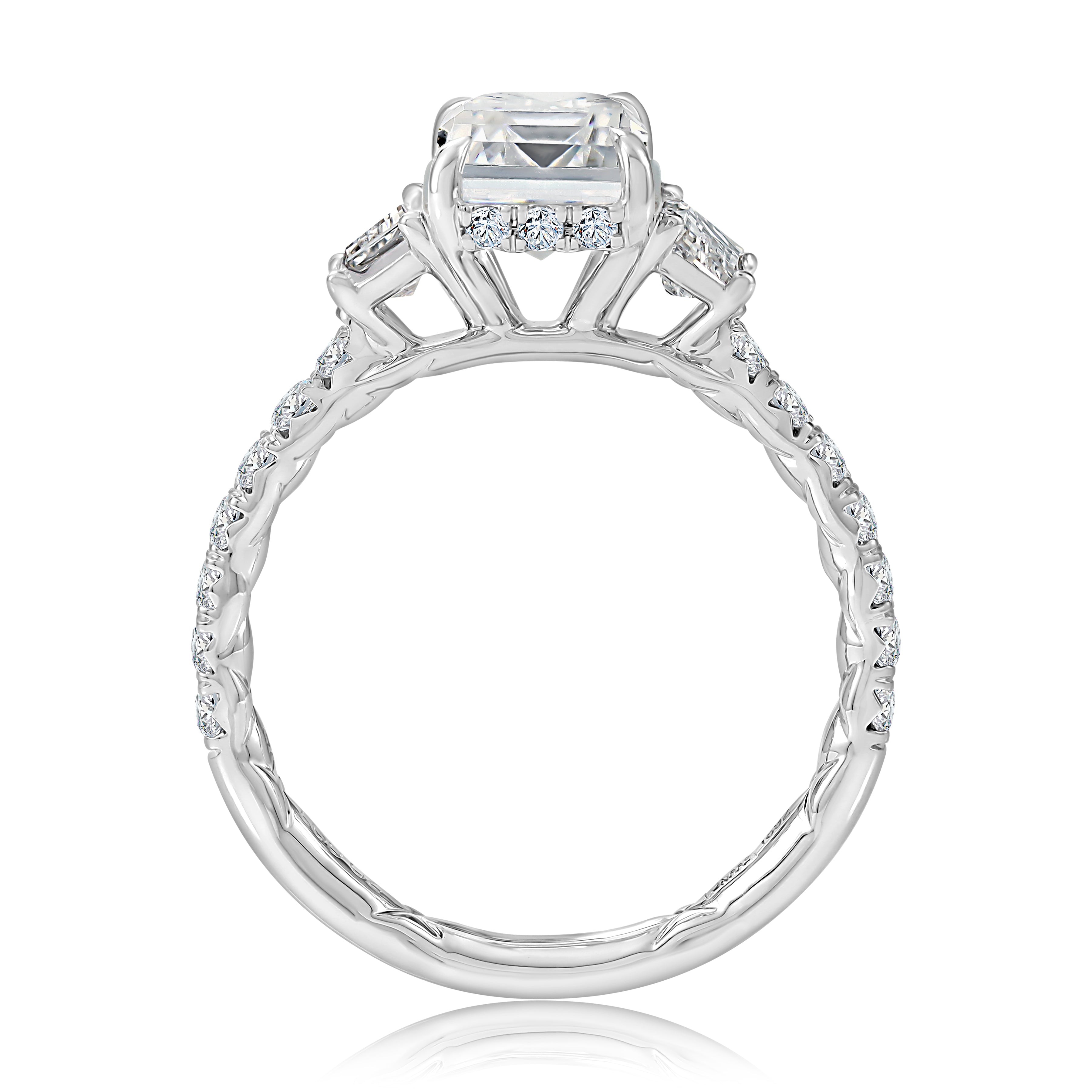 Side view of a 14K white gold three-stone engagement ring setting with a pave diamond band