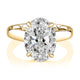 Top view of a 14K yellow gold hidden halo engagement ring with an oval center diamond