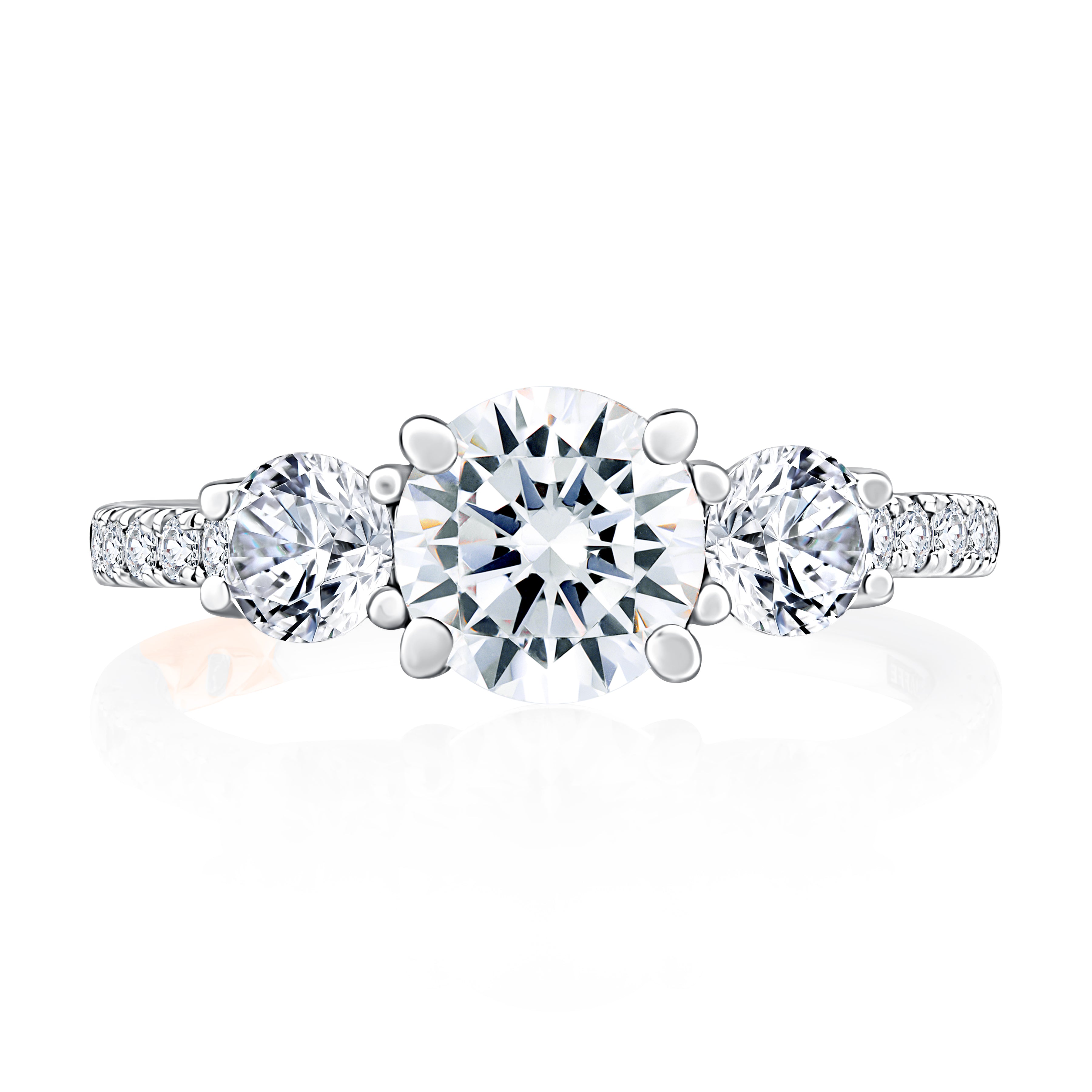 Top view of a 14K white gold three-stone engagement ring with a round center diamond