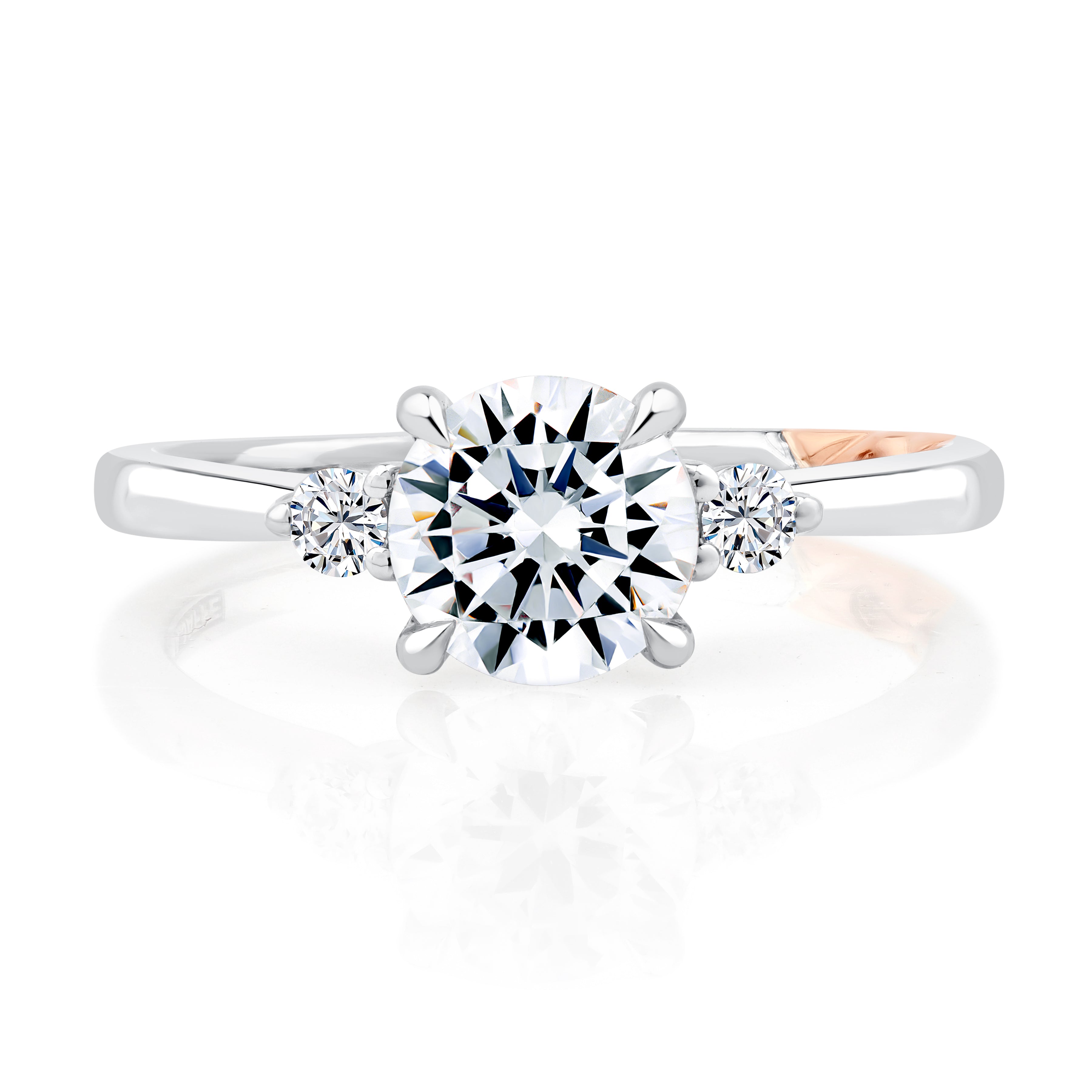 Top view of a 14K white gold three-stone engagement ring with a round center diamond